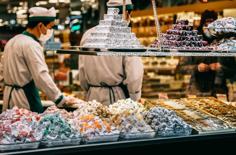 Orientalischer Süßigkeitenmarkt mit zwei Verkäufern als Symbol für Suche über verschiedene Datenquellen
