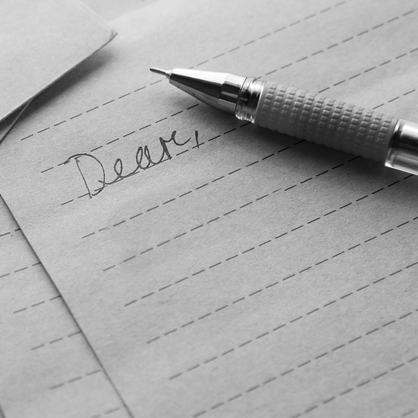  A pen, paper and the written word "dear"