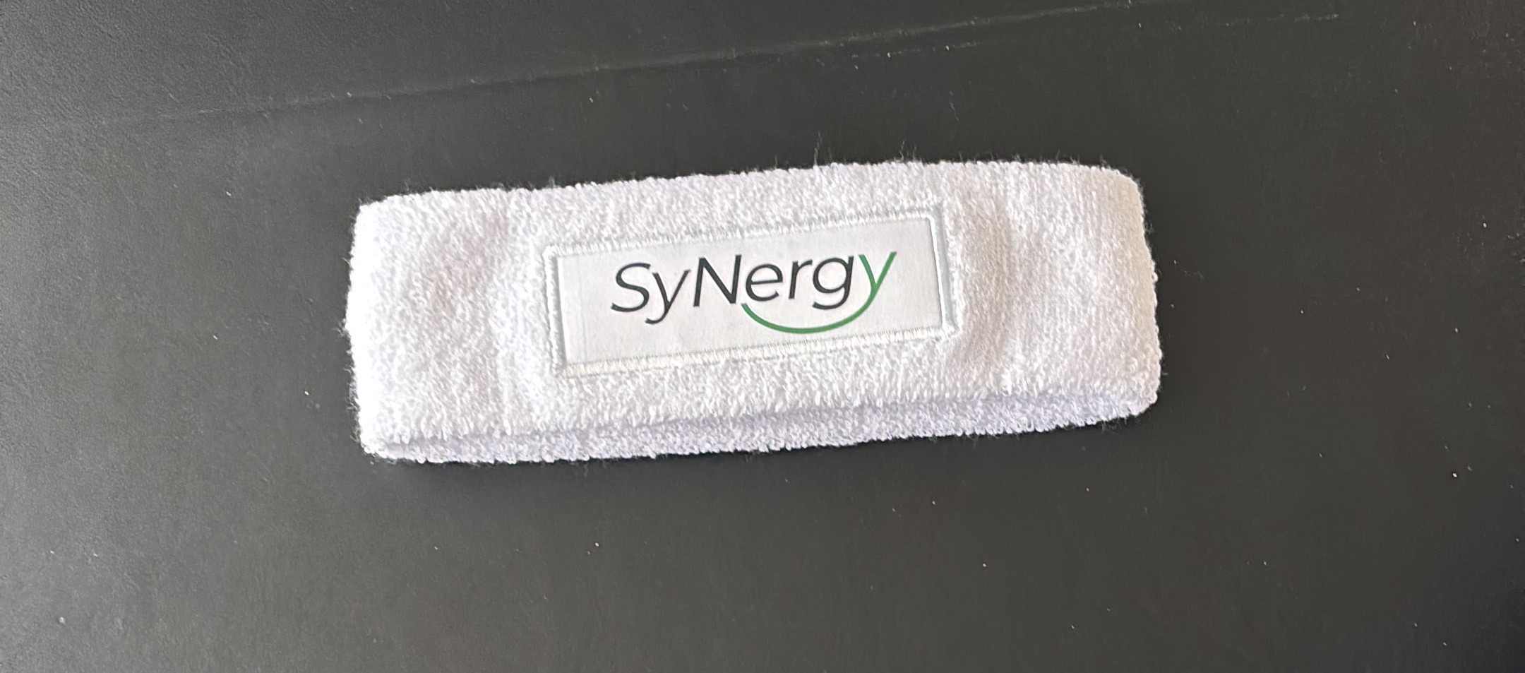  A white head band with SyNergy logo