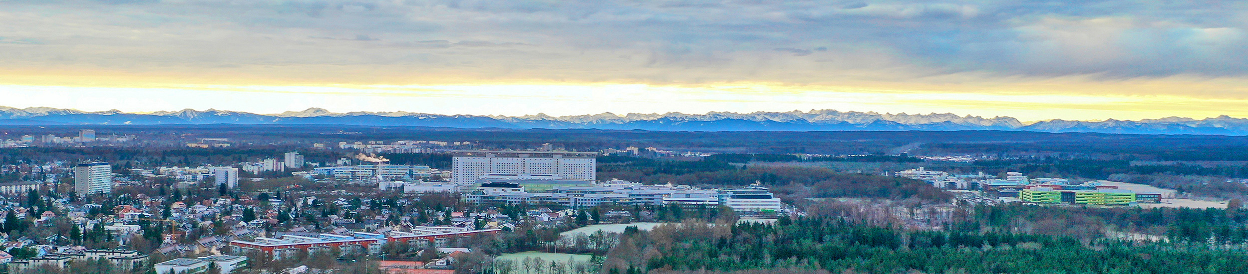 LMU KLinikum: Das Bettenhaus im Zentrum des Campus Gro0hadern mit den Alpen am Horizont.