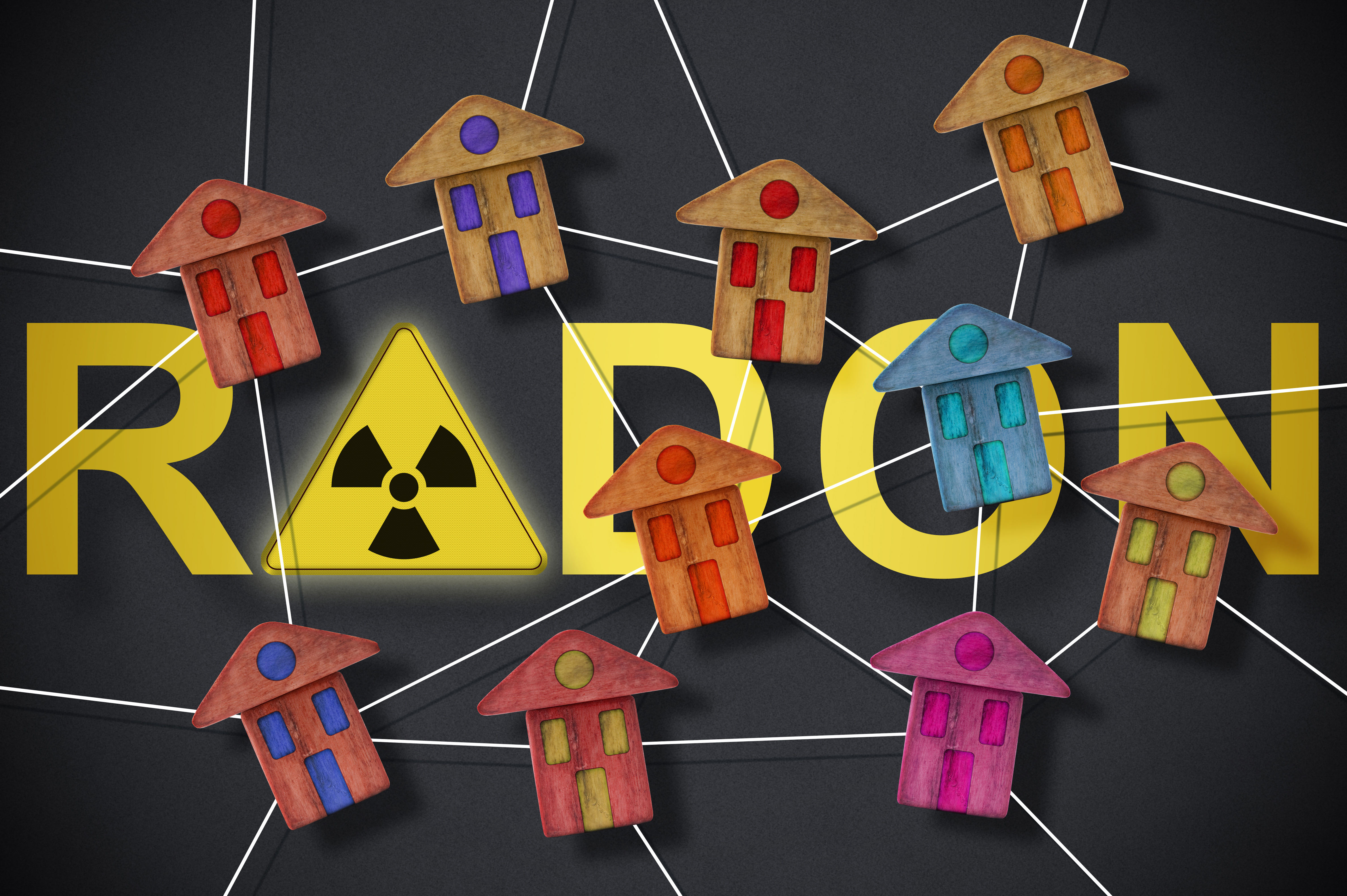 Aufschrift Radon, darum sind kleine Häuschen vor dunklem Hintergrund