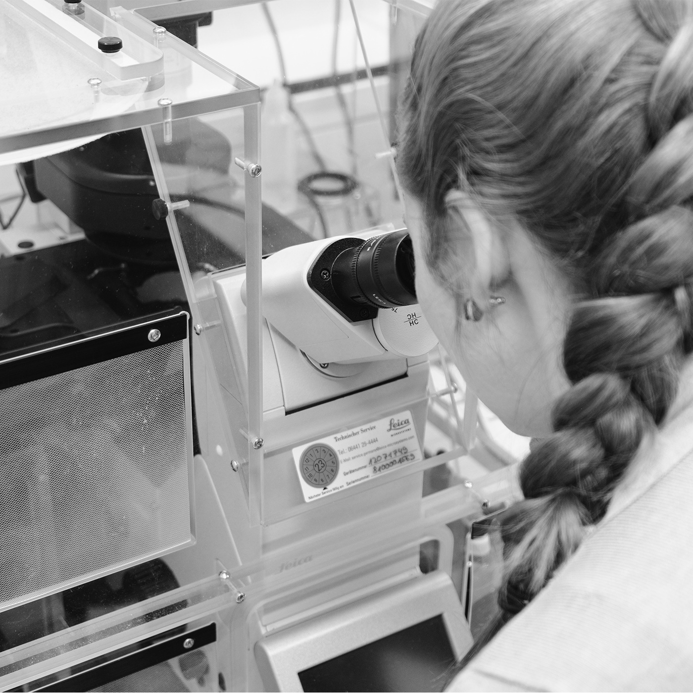  Female looking through microscope