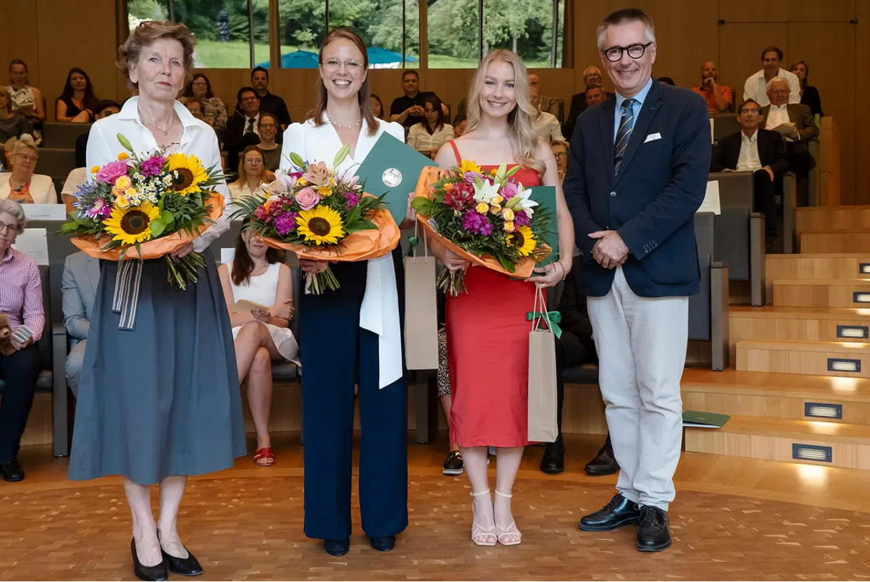  Gloria Biechele holding flowers and award